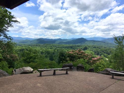 a bench sitting on top of a hill with a view at Lodge at Bradley Mtn in Townsend