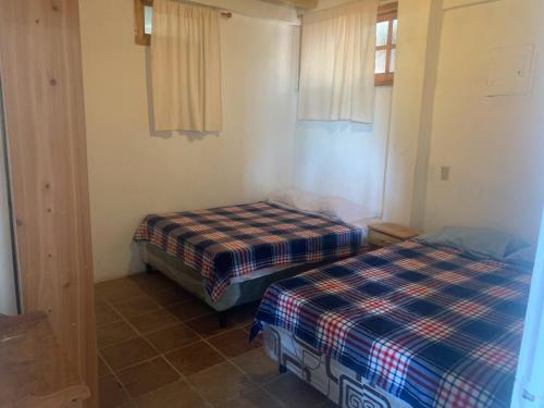 a room with two beds in a room at Hostal Dulces Sueños in Panajachel