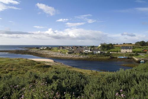a view of a river with houses and the ocean at Royal Marine Hotel in Brora