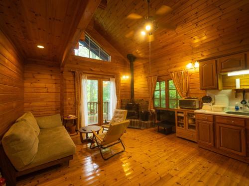 a living room with a couch in a log cabin at Nasu-gun - House - Vacation STAY 13478 in Anazawa