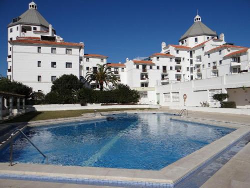 a large swimming pool in front of a building at Porto Marina @Vilamoura in Vilamoura