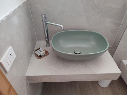 a bathroom with a bowl sink on a counter at Storie di bosco in Villa Lagarina