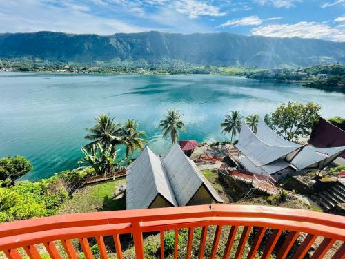 a view of a large body of water with palm trees at Vandu's View Guest house & Restaurant in Tuk Tuk