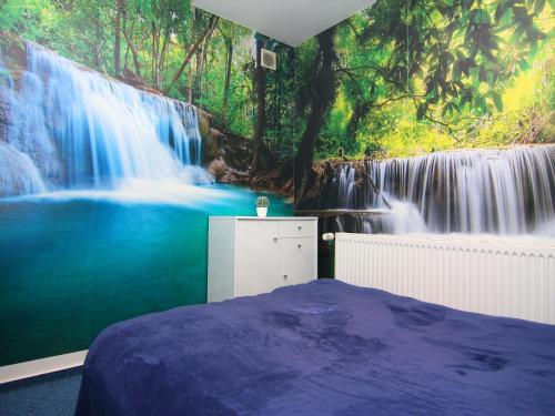 a bedroom with a mural of a waterfall at Ferienwohnung am Prüßsee in Güster in Güster