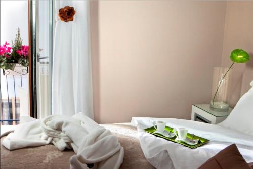 a bedroom with a bed with towels on it at Bougainvillea Relais in Sorrento