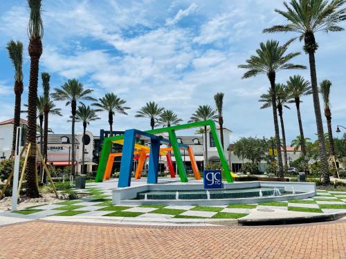 a playground in a park with palm trees at Crowne Plaza Ft Myers Gulf Coast by IHG in Fort Myers