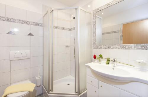 a bathroom with a shower and a sink and a toilet at Villa Alpin in Obergurgl