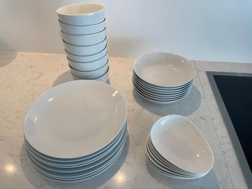 a group of white plates sitting on a table at Villa Mariso “貸別荘マリソ“ in Noma