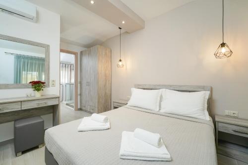 a bedroom with a large bed with white pillows at Villa Oresti in Panagia