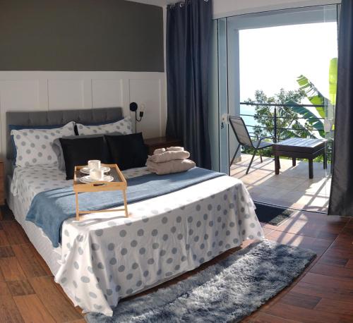 a bedroom with a bed with a table on it at Suite com piscina in Florianópolis