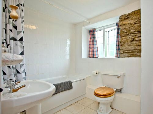 a white bathroom with a toilet and a sink at Granary - Uk31175 in Saint Martin