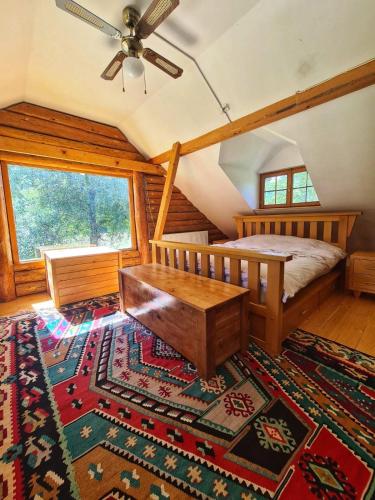 a bedroom with a bed and a ceiling fan at Villa California in Rezine
