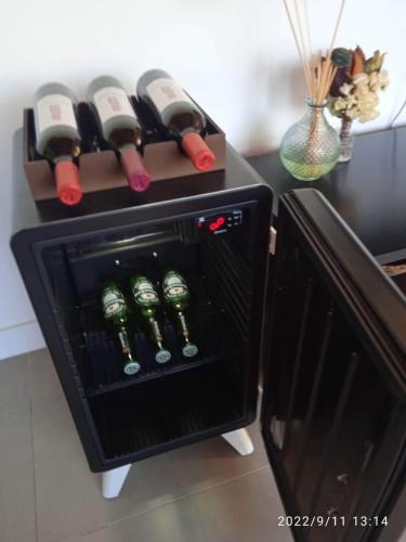 a wine rack with wine bottles on a counter at A Casa Azul - Igatu in Igatu