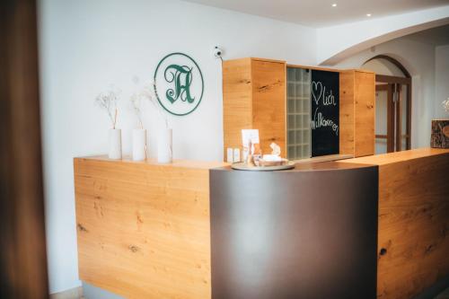 a counter in a room with wooden cabinets at Angermühle Landgasthof in Altenmarkt an der Alz