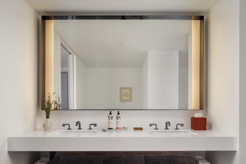 a bathroom with two sinks and a large mirror at The LINE San Francisco in San Francisco