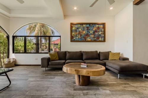 a living room with a couch and a coffee table at Mexican Lagoon front Villa by CASA PARAISO in Cancún