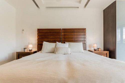 a bedroom with a large bed with two night stands at Mexican Lagoon front Villa by CASA PARAISO in Cancún