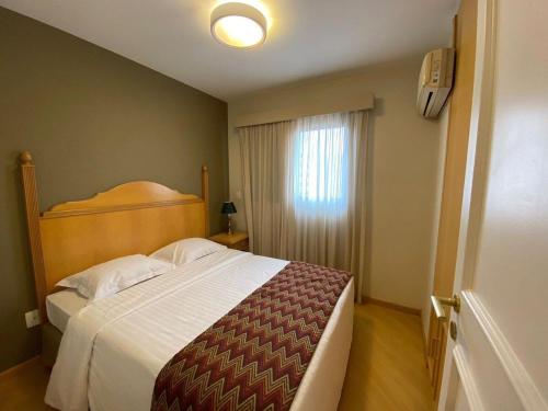 Un dormitorio con una cama grande y una ventana en Flat Residence Moema c/ cozinha e lavadora UH104 en São Paulo