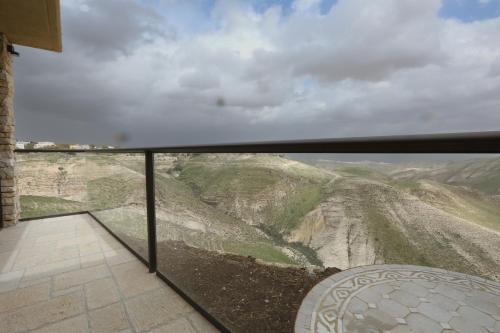 a room with a view of a mountain at Genesis Land Desert hospitality in Kfar Adumim