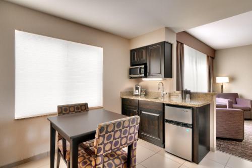 a kitchen with a table and chairs in a room at Holiday Inn Express Hotel & Suites Billings by IHG in Billings