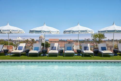 a hotel room with lawn chairs and umbrellas at Kimpton Canary Hotel, an IHG Hotel in Santa Barbara