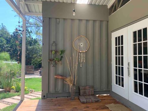a patio with a gray wall and a door at Wabi Sabi , casa de playa in Tamanique
