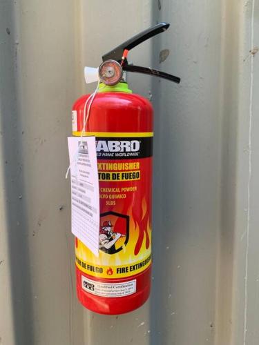 a fire extinguisher is attached to a wall at Wabi Sabi , casa de playa in Tamanique
