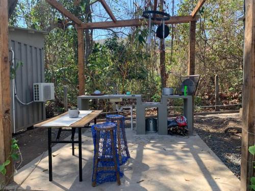 a patio with a table and two stools at Wabi Sabi , casa de playa in Tamanique