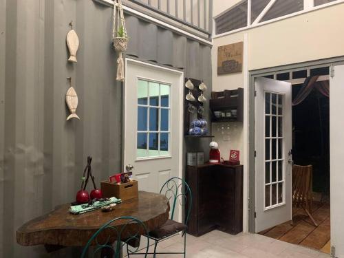 a kitchen with a wooden table and chairs in a room at Wabi Sabi , casa de playa in Tamanique