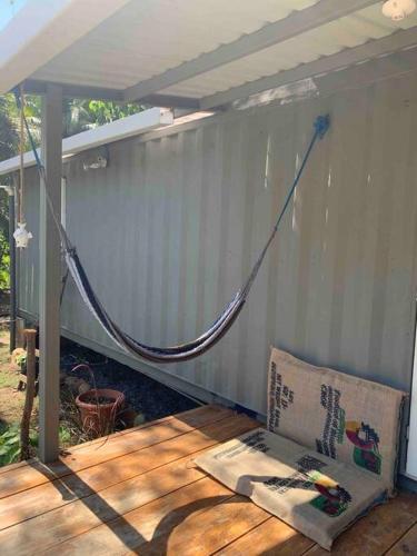 a porch with a hose attached to a wall at Wabi Sabi , casa de playa in Tamanique