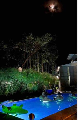 a blue table in a yard at night at Wabi Sabi , casa de playa in Tamanique