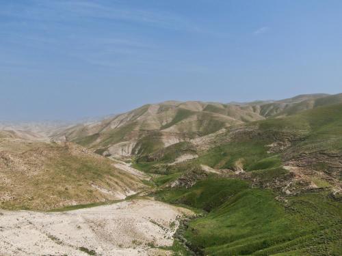 a view of a mountain with the ocean in the background at Genesis Land Desert hospitality in Kfar Adumim