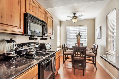 a kitchen with a stove and a table with chairs at Downtown Condo Near the Convention Center in Salt Lake City