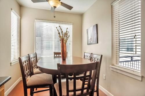 a dining room with a table and chairs and windows at Downtown Condo Near the Convention Center in Salt Lake City