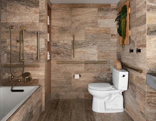 a bathroom with a toilet and a bath tub at 1 Hotel Nashville in Nashville