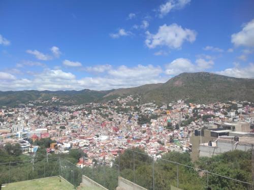 a view of a city with mountains in the background at La Casa Rosa Guanajuato in Guanajuato