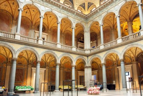 a large room with columns and ceilings in a building at Grand Hotel Wien in Vienna