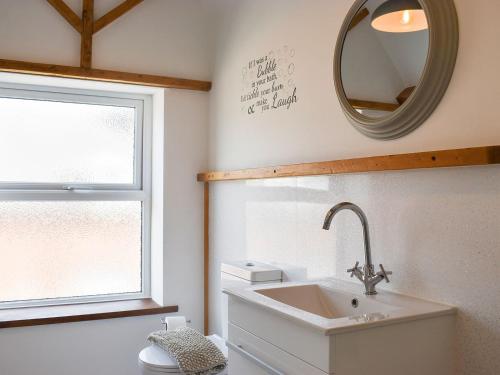 a bathroom with a sink and a mirror at Warehouse Number 3 in Bridlington
