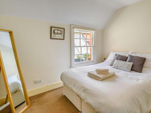 a bedroom with a large white bed with a window at Top Flat-uk35142 in Lincoln