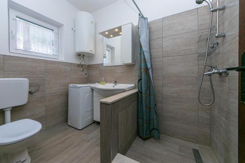 a bathroom with a toilet sink and a shower at Apartments with a parking space Gradac, Makarska - 14708 in Gradac