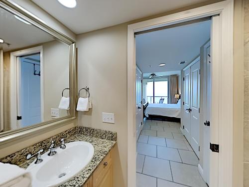 a bathroom with a sink and a large mirror at Portofino Island Resort #4-1905 in Pensacola Beach