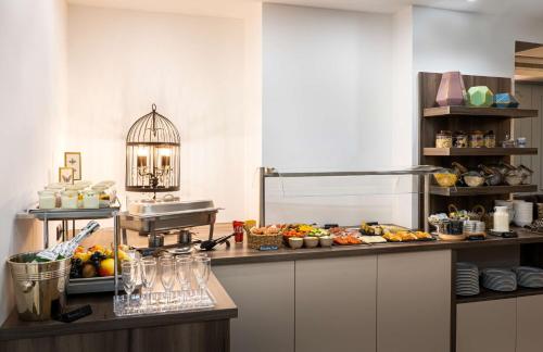 a kitchen with a bunch of food on a counter at elaya hotel vienna city center in Vienna