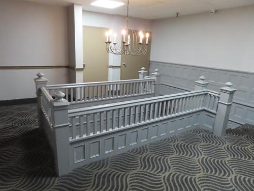 a staircase in a room with a chandelier at St Charles Hotel Downtown Hudson in Hudson