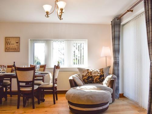 a living room with a table and chairs and a dining room at Wesley Old Hall House in Bacup