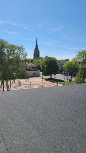 a large parking lot with a church in the background at Cozy Studio in Palanga City Center in Palanga