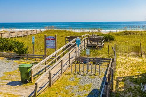 a path to the beach with the ocean in the background at Seaview Duplex 7 in Kure Beach