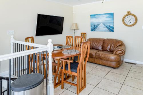 a living room with a table and a couch at Seaview Duplex 6 in Kure Beach