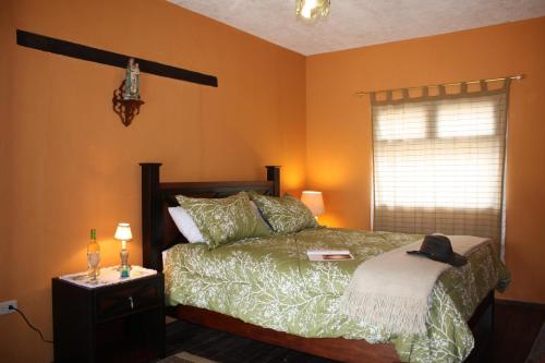a bedroom with a bed with a hat on it at Hacienda La Merced Baja in Zuleta