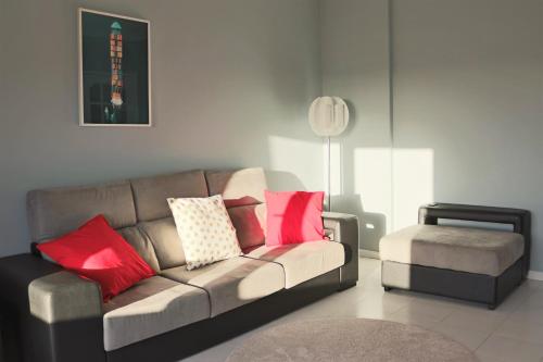 a living room with a couch and a stool at Сomfortable apartments and free garage parking in Porto