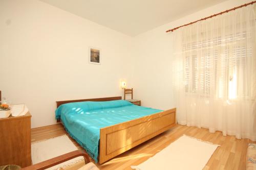 a bedroom with a bed and a large window at Apartments by the sea Ugljan - 348 in Ugljan